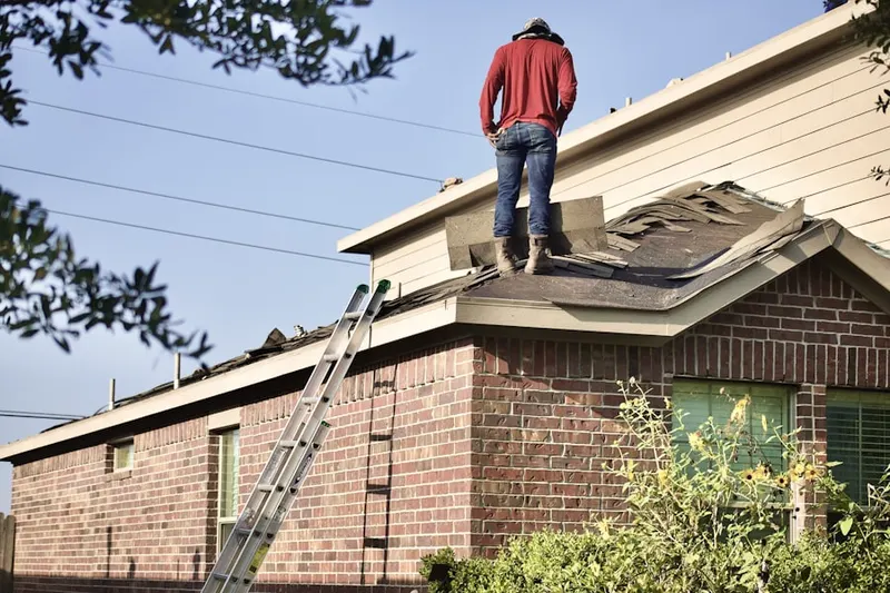 Professional roofer working on a residential roof in Meadows of North Lewisburg